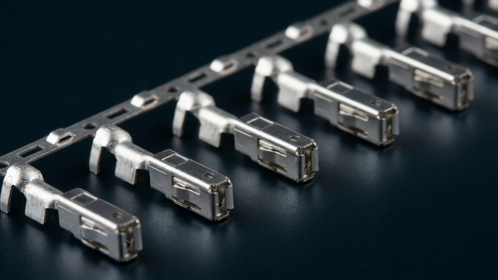 Bright tin-plated crimp terminals on their carrier strip