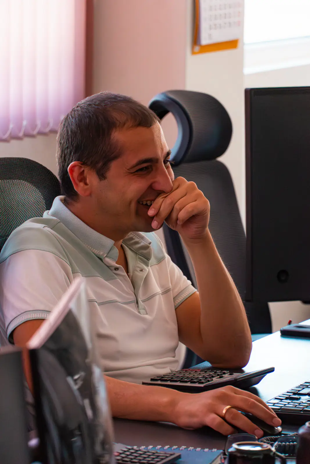 A Harness Code specialist at his desk, mid conversation with a customer